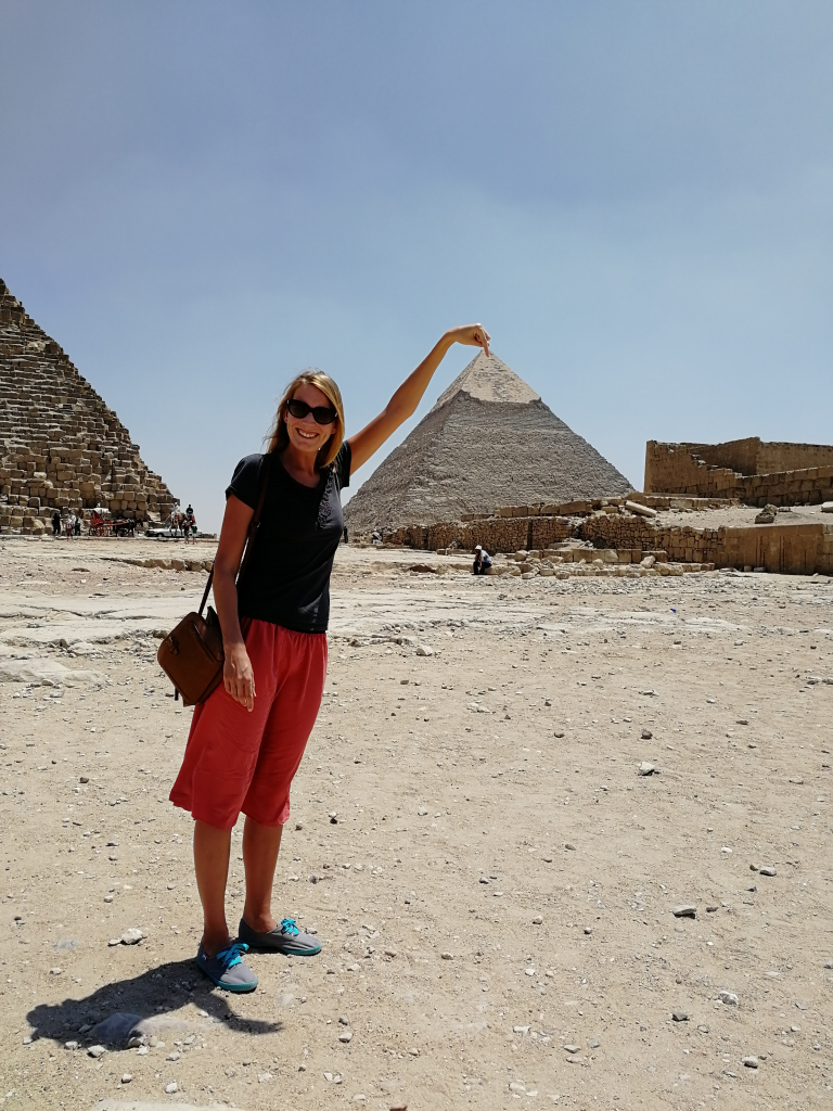 woman standing by pyramids of Giza